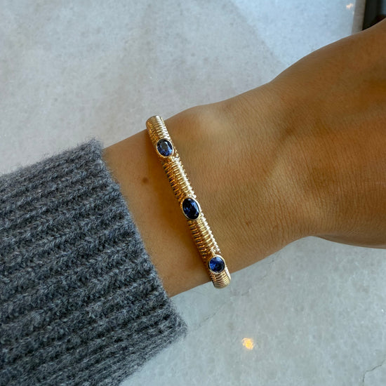 Gold Ribbed Cuff with Three Station Oval Blue Sapphires