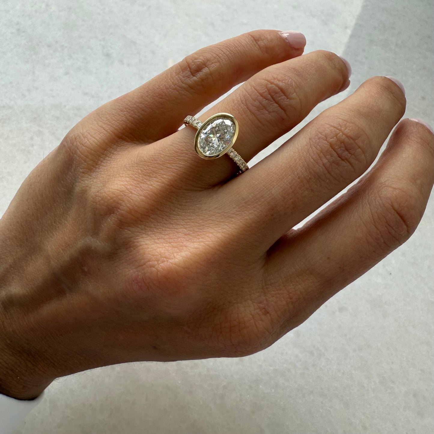 Lab Grown Oval Bezel Engagement Ring on Pave Diamond Band